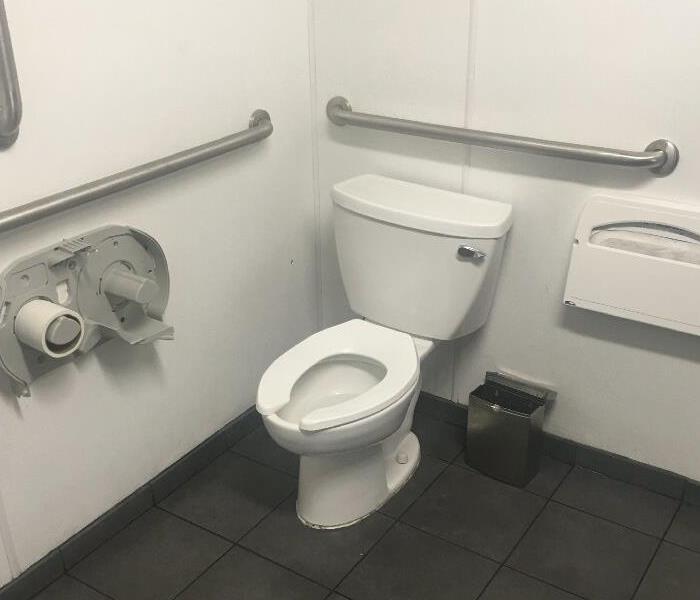 Photo of bathroom stall cleaned after Vandalism. 